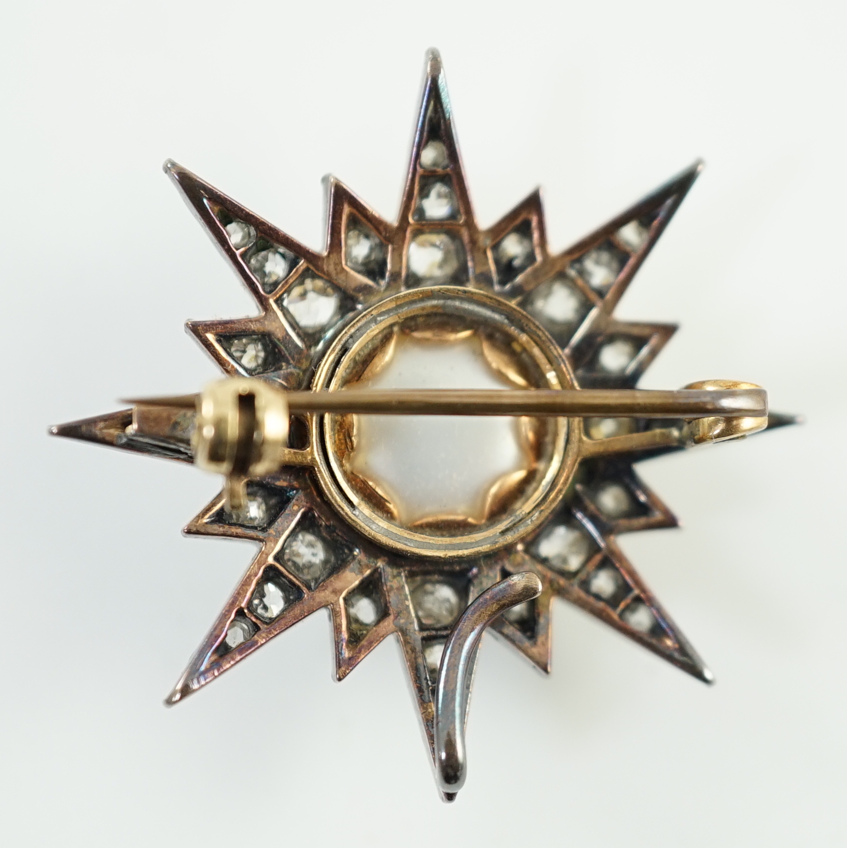 A Victorian gold and silver, button pearl and graduated round and rose cut diamond set cluster starburst brooch